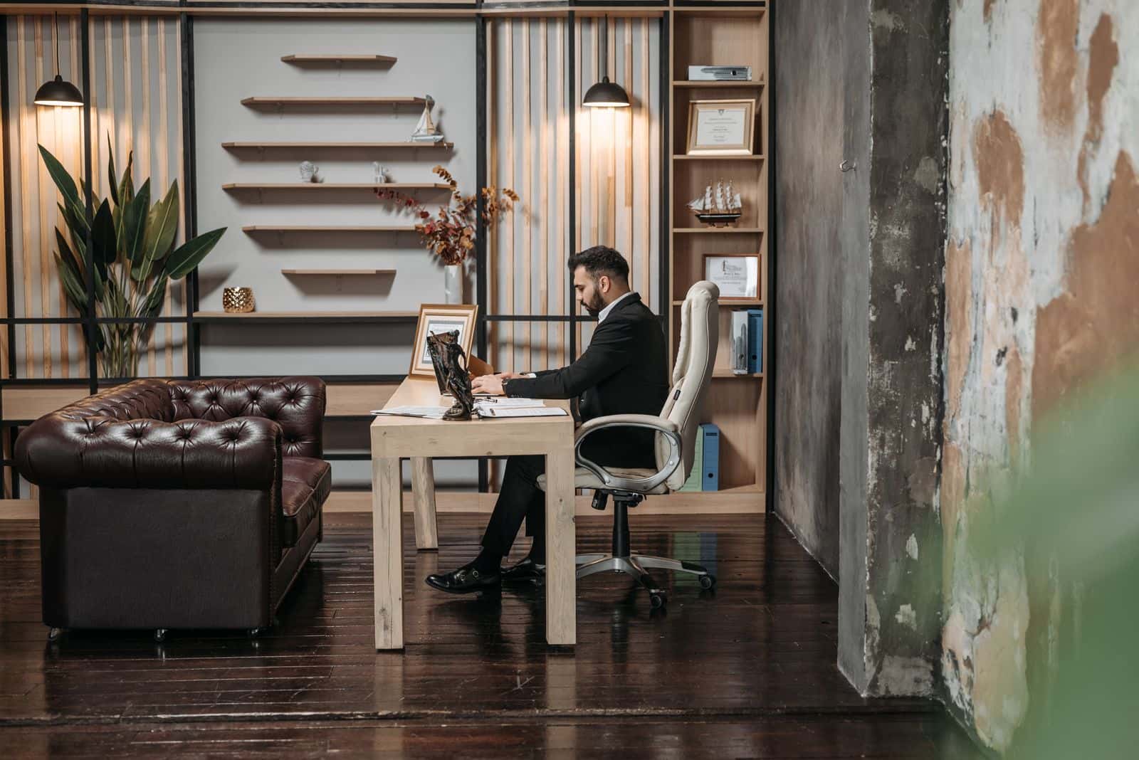 A man working at a single desk in a large office