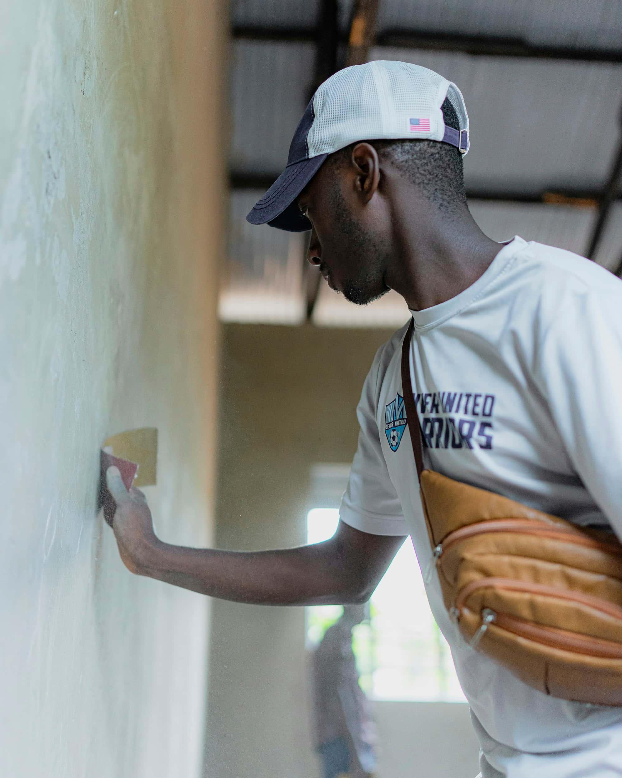 A subcontractor plastering a wall