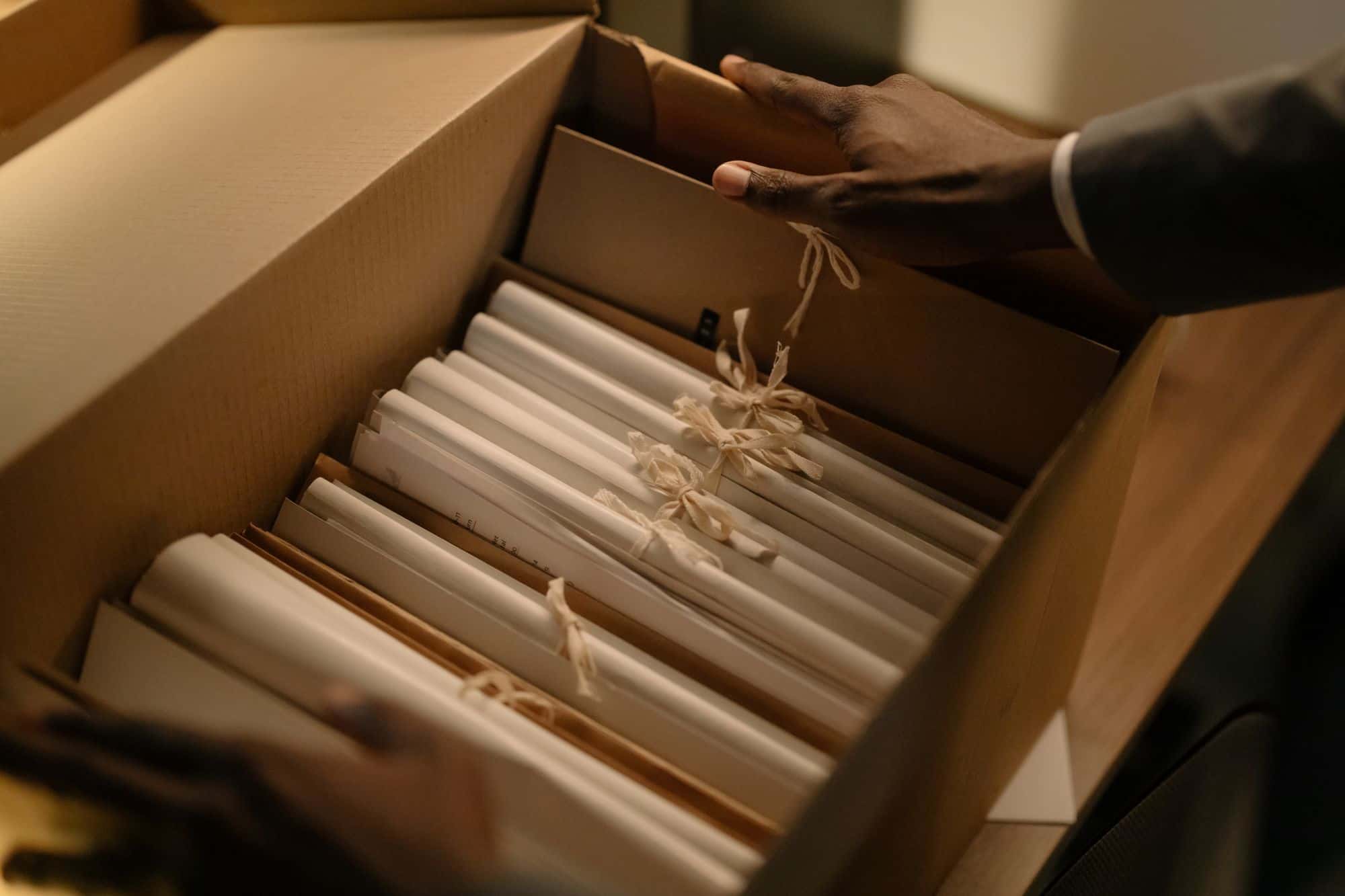 A box of old invoices and receipts waiting to be sorted