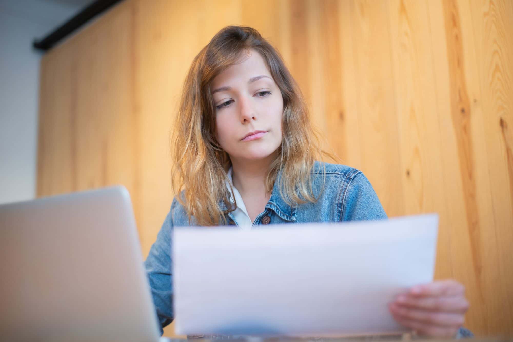 Somebody checking a document by a window