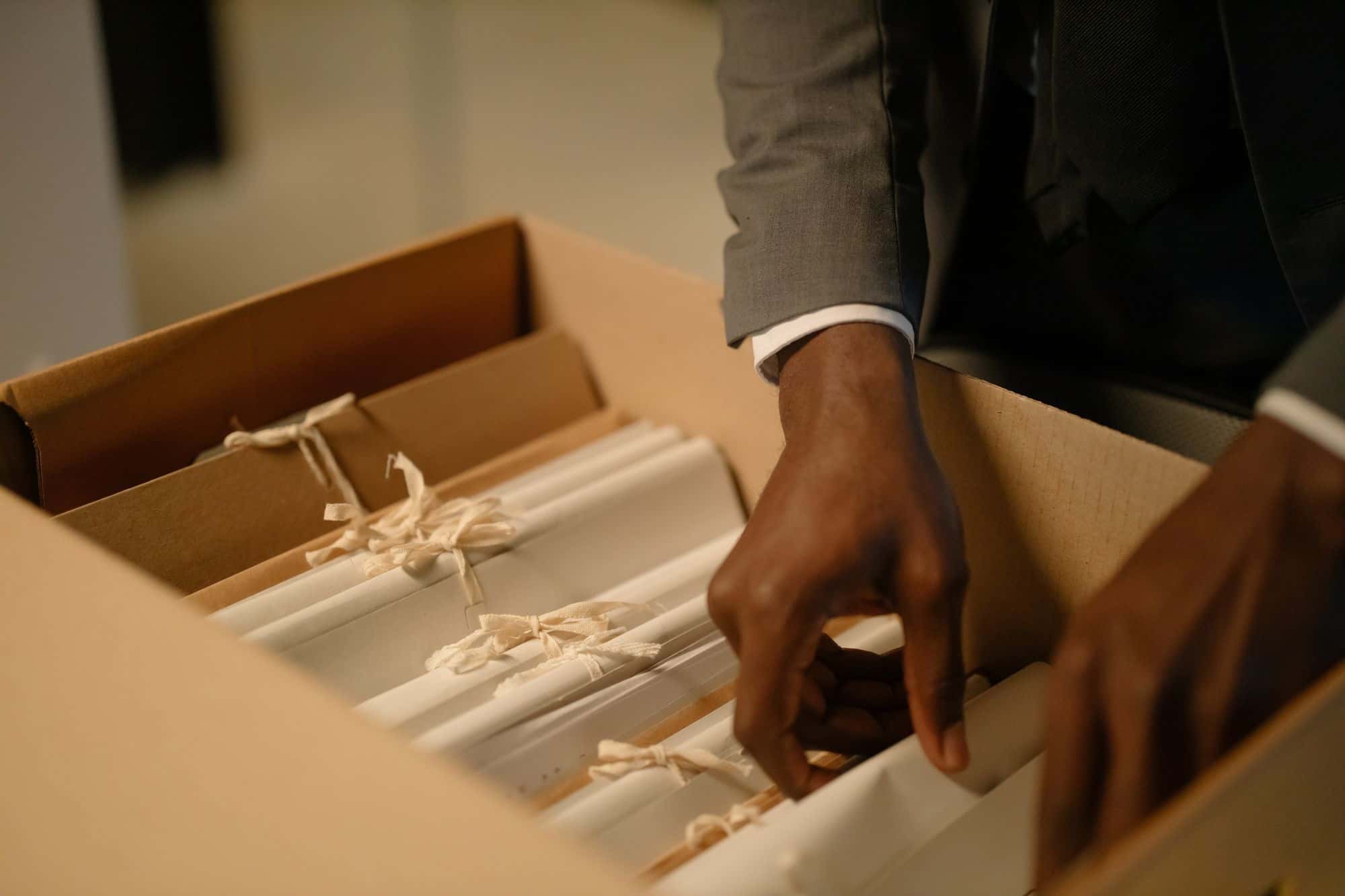 Hands sorting through filed documents