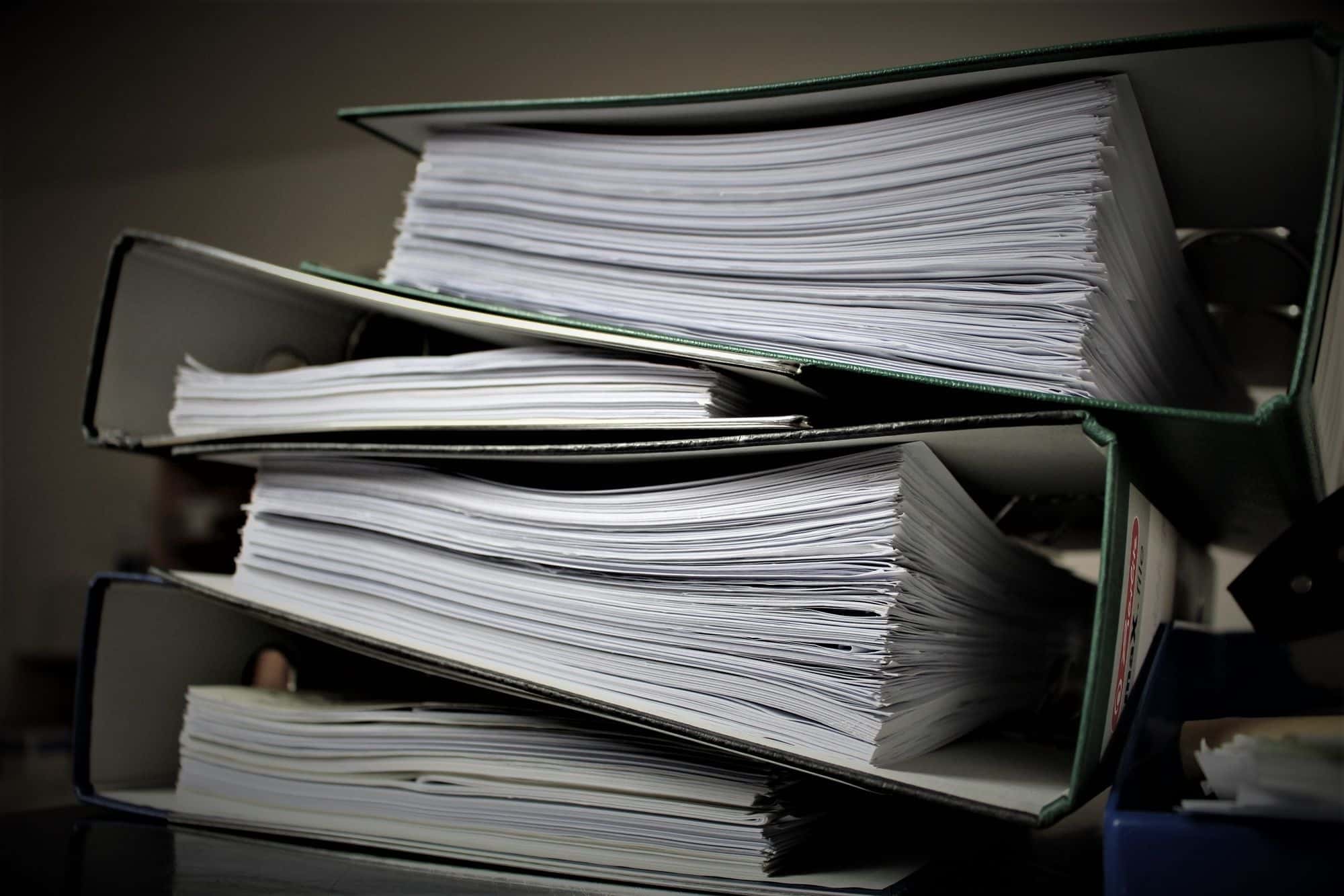 A stack of full lever arch files on a shelf