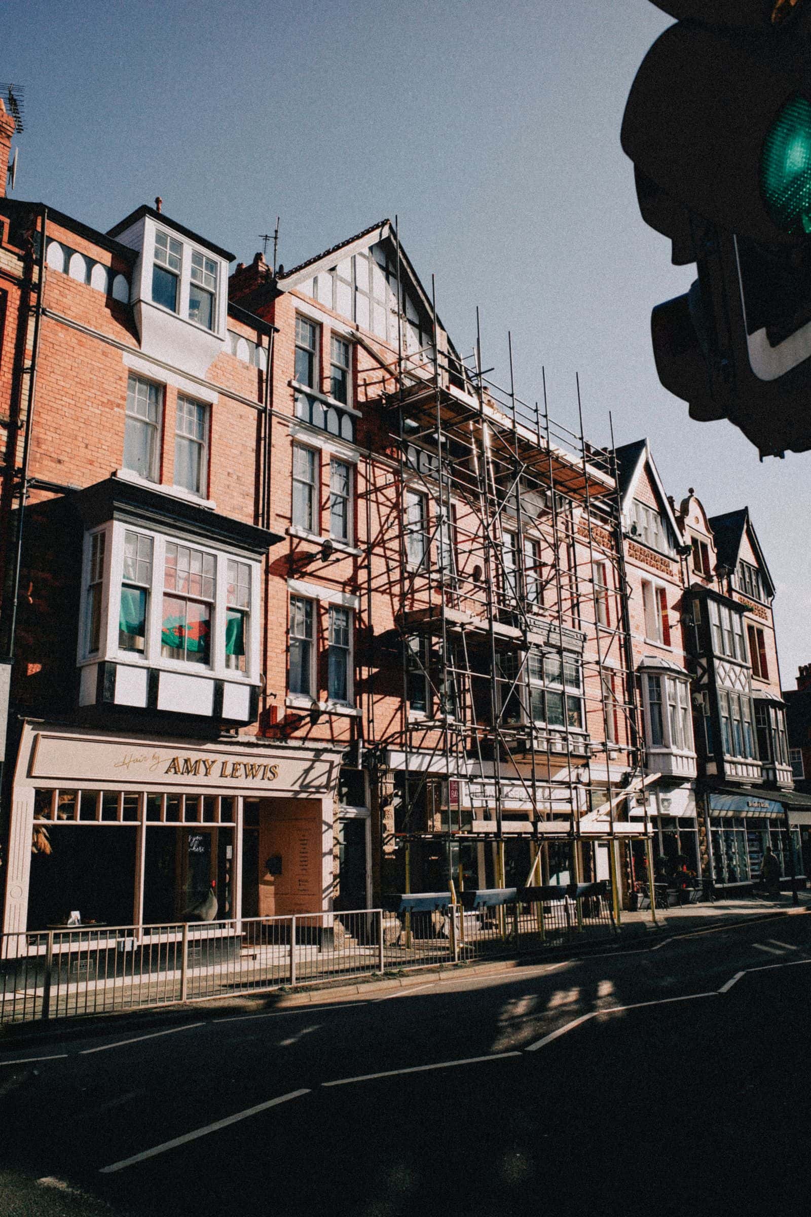 A UK terraced street with scaffolding up the front